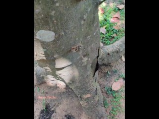 Girl pissed near a big old tree with one leg up