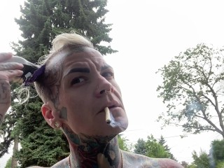 Butch dyke smokes and shaves head flexes muscles