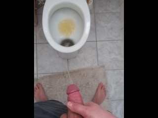 Big and hard cock of a young guy gives out a golden shower in the morning