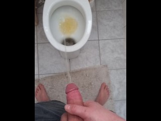 Big and hard cock of a young guy gives out a golden shower in the morning