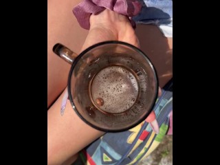 A blondie teen is smoking coughing hocking and spitting loogies into a glass