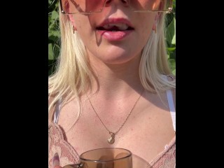 A blondie girl is coughing and hocking a really big loogie spitting it out and showing it