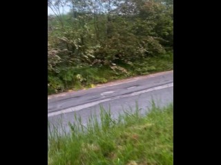 Naked barefoot walk on path at side of road