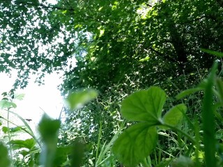 Mother-in-law bends down deeply to pee in nature next to son-in-law