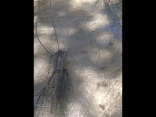 Cute long hair girl on her knees looking for shells to collect in popular spring creek part 2