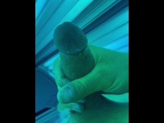 Tug job in public tanning bed with huge cum fountain