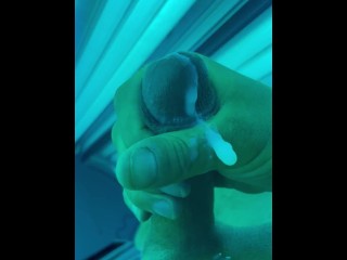 Tug job in public tanning bed with huge cum fountain