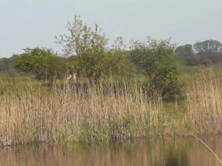 Wild beach on shore of lake sexy MILF sunbathing, fingers masturbating wet pussy and strong orgasm.