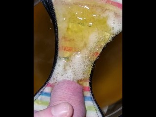 Pissing onto panties in a bowl in slow motion