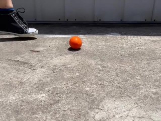 Crushing a small tomato and orange
