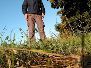 Mother-in-law in a new dress bends over and pisses in nature with her son-in-law