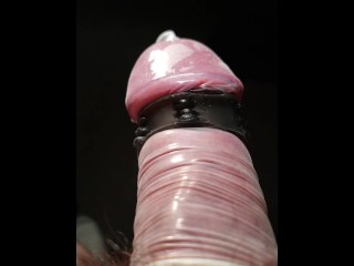 Close up POV of vibrating penis in slow motion while wearing condom