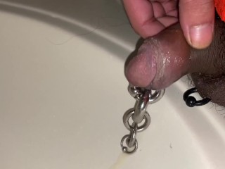 Pre cum dripping from pierced cock after piss