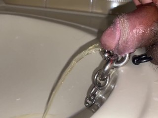 Pre cum dripping from pierced cock after piss