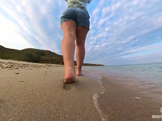 Barefoot Girl Walks Over The Summer Seashore