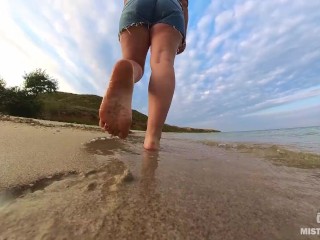 Barefoot Girl Walks Over The Summer Seashore