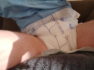 Urinating in a diaper with an inserted catheter after filling the bladder, relaxing...