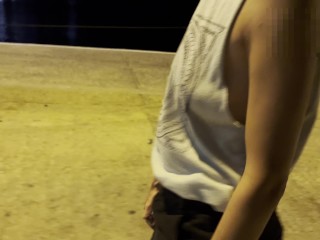 Night walking at the sea port with side cut shirt, showing tits and nipples in public around people