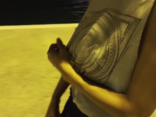 Night walking at the sea port with side cut shirt, showing tits and nipples in public around people