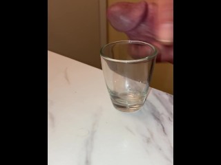 Collecting my cum in a shot glass, breathing heavy and moaning squeezing it out of my dick