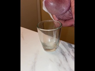 Collecting my cum in a shot glass, breathing heavy and moaning squeezing it out of my dick