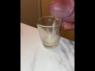 Collecting my cum in a shot glass, breathing heavy and moaning squeezing it out of my dick