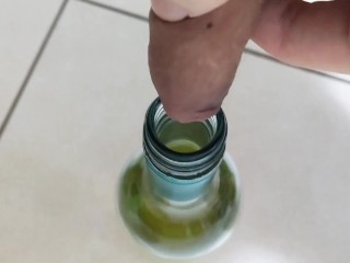 Filling up a 750mL bottle of wine with piss