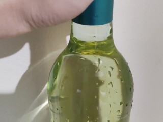 Filling up a 750mL bottle of wine with piss