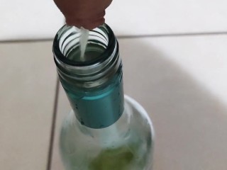 Filling up a 750mL bottle of wine with piss