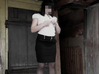 Pissing while standing in the courtyard of an abandoned house by a mature milf with a hairy pussy in