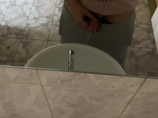 Pissing in a public toilet in the sink, filming through the mirror