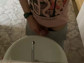 Pissing in a public toilet in the sink, filming through the mirror