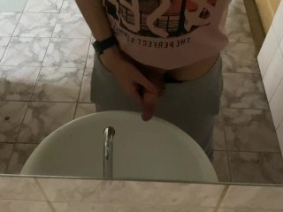 Pissing in a public toilet in the sink, filming through the mirror