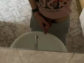 Pissing in a public toilet in the sink, filming through the mirror