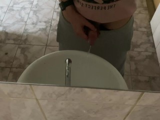 Pissing in a public toilet in the sink, filming through the mirror