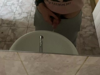 Pissing in a public toilet in the sink, filming through the mirror