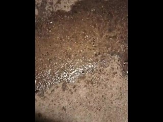 Pissing by a drain on the sidewalk