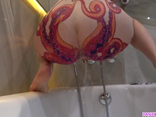 Housewife with octopus tattooed ass pisses in a bathroom back view