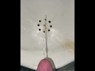 Guy pees in a urinal very close POV