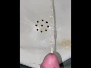 Guy pees in a urinal very close POV