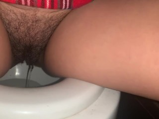 Naughty school girl peeing in the toilet