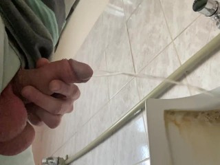 A guy pisses in a public office toilet. POV 4K