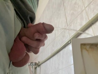 A guy pisses in a public office toilet. POV 4K