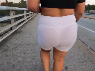 White see through shorts with white thong walking