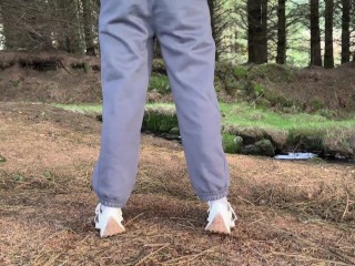 Girls peeing near the forest on the public road