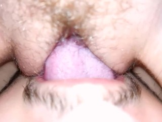 The wife moans from cunnilingus, close-up, sitting on her face with a wet pussy.