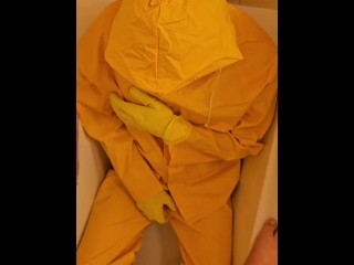 Pissing over  yellow rainwear with yellow gloves and latex mask