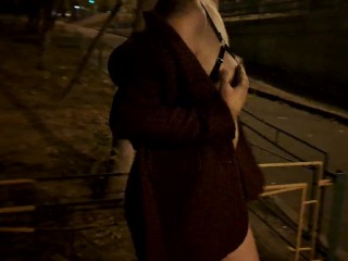 Naked girl walks through the city at night