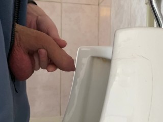 A guy pisses in a public urinal from an uncut penis without opening it 4K