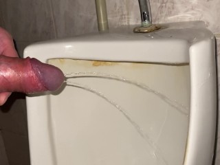 Quick pissing in a public toilet close up